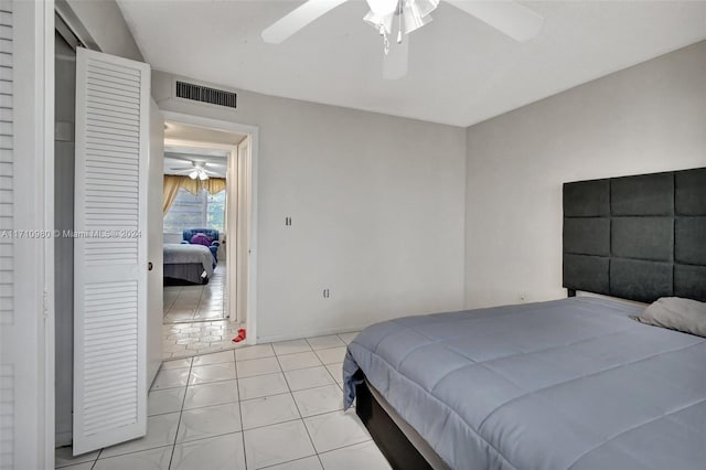 bedroom with ceiling fan and light tile patterned floors