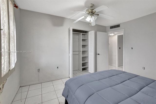 bedroom with a closet, ceiling fan, and light tile patterned flooring