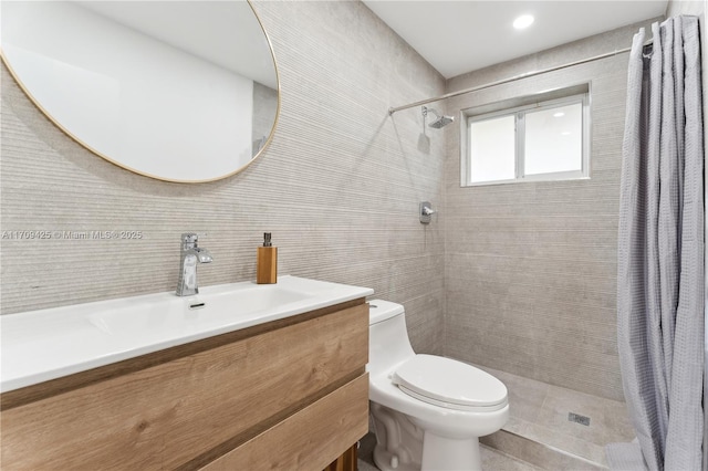 bathroom featuring tile walls, decorative backsplash, vanity, walk in shower, and toilet