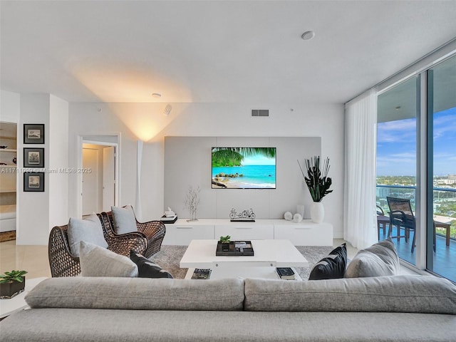 living room with expansive windows and visible vents