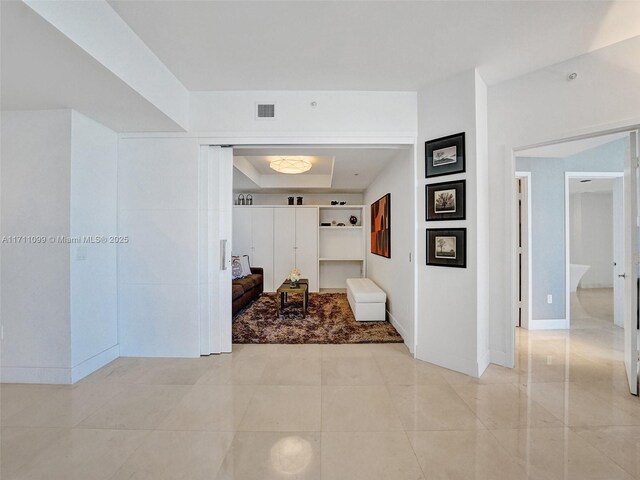 17301 Biscayne Blvd Unit 2008, North Miami Beach, FL 33160 - corridor featuring a raised ceiling, baseboards, and visible vents
