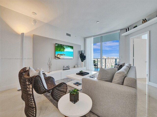 17301 Biscayne Blvd Unit 2008, North Miami Beach, FL 33160 - living room with baseboards, visible vents, and a wall of windows