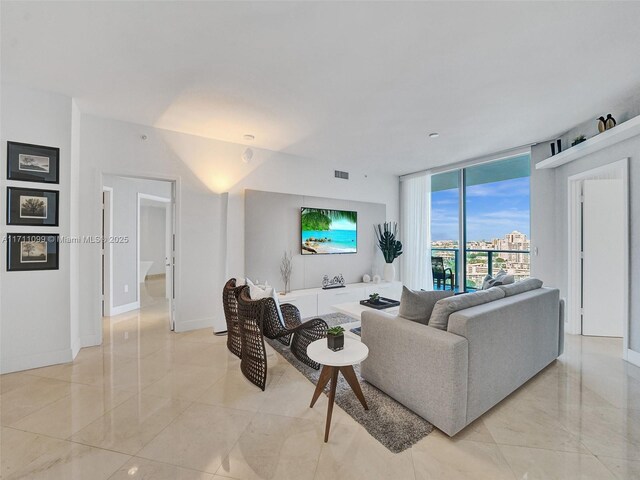 17301 Biscayne Blvd Unit 2008, North Miami Beach, FL 33160 - living area featuring baseboards, expansive windows, and visible vents