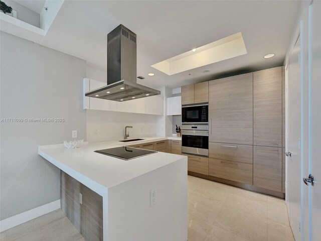 17301 Biscayne Blvd Unit 2008, North Miami Beach, FL 33160 - kitchen with island range hood, a skylight, a peninsula, modern cabinets, and black appliances