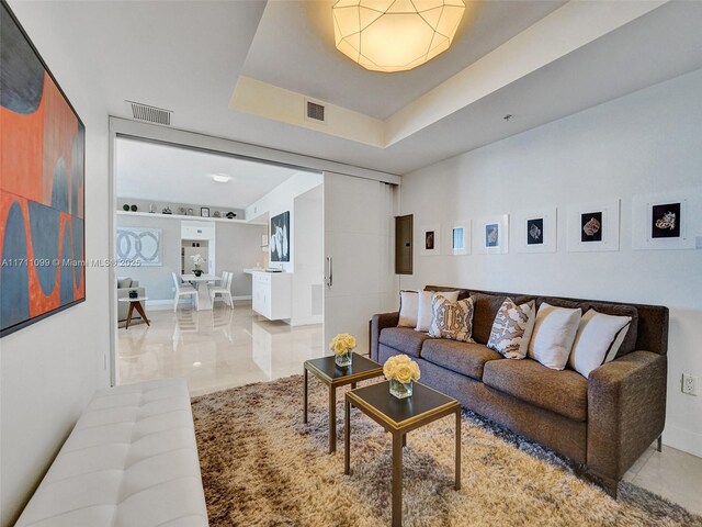 17301 Biscayne Blvd Unit 2008, North Miami Beach, FL 33160 - living area with a tray ceiling, baseboards, and visible vents