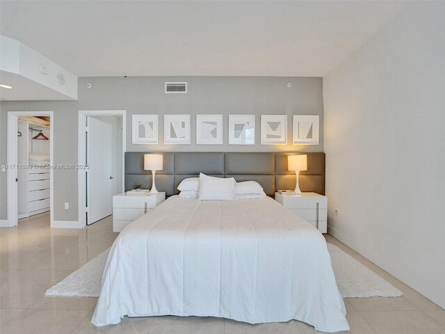 17301 Biscayne Blvd Unit 2008, North Miami Beach, FL 33160 - bedroom with a spacious closet, light tile patterned floors, and visible vents