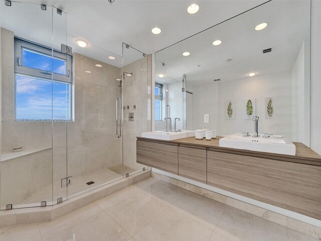 17301 Biscayne Blvd Unit 2008, North Miami Beach, FL 33160 - bathroom featuring a stall shower, double vanity, recessed lighting, and a sink