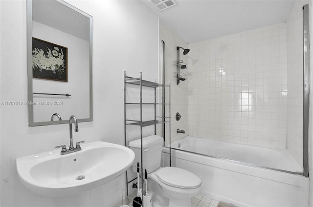 full bathroom with tile patterned flooring, sink, tiled shower / bath, and toilet