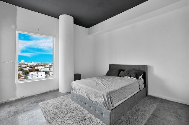 bedroom featuring concrete flooring