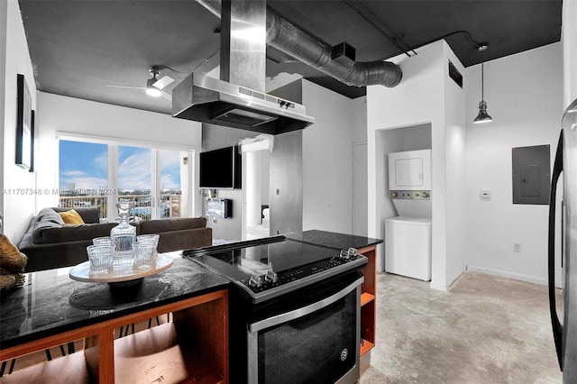 kitchen with ceiling fan, stacked washer and dryer, stainless steel range with electric cooktop, and electric panel