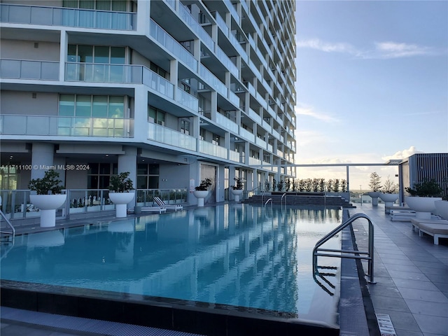 pool at dusk with a water view