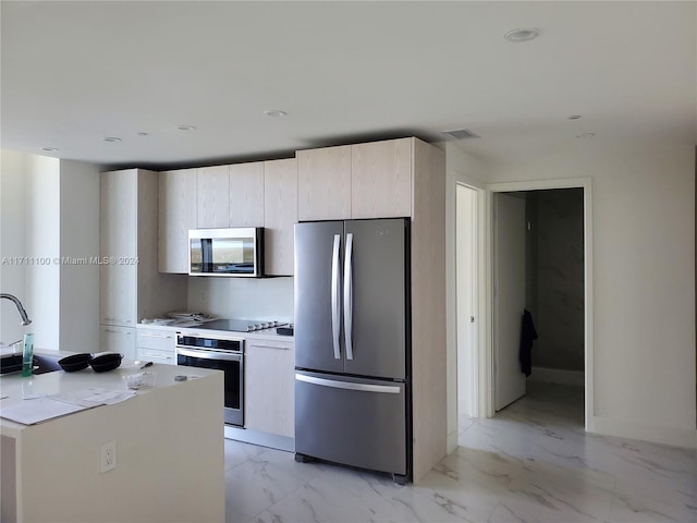 kitchen with light stone counters and stainless steel appliances