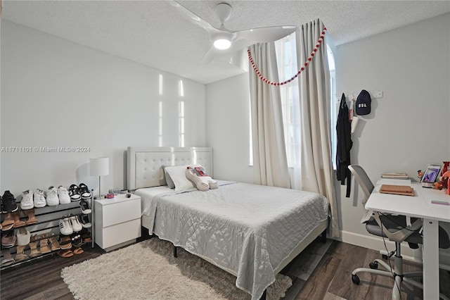 bedroom featuring a textured ceiling, dark hardwood / wood-style floors, and ceiling fan