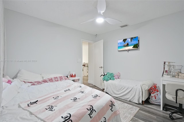 bedroom with hardwood / wood-style floors and ceiling fan