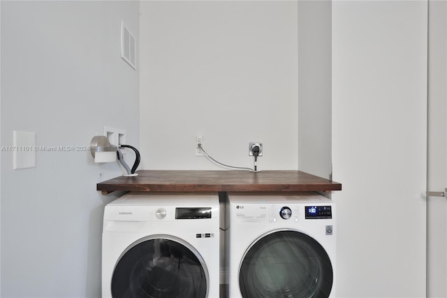 washroom with washing machine and clothes dryer