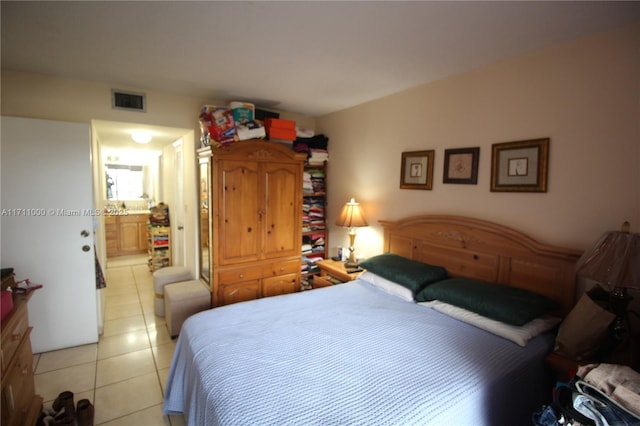 bedroom featuring light tile patterned floors and visible vents