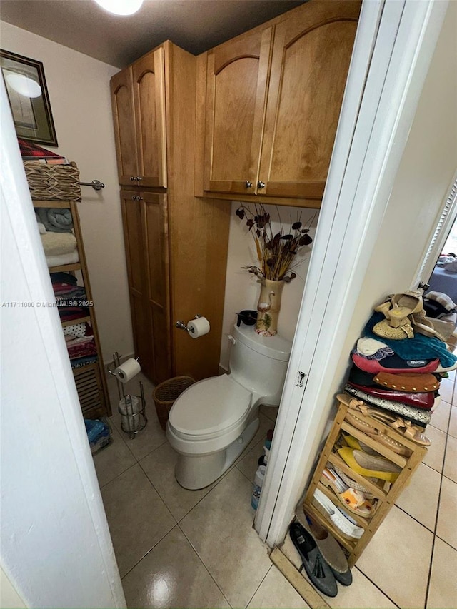 bathroom with tile patterned flooring and toilet