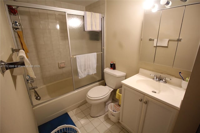 full bathroom featuring combined bath / shower with glass door, vanity, toilet, and tile patterned floors