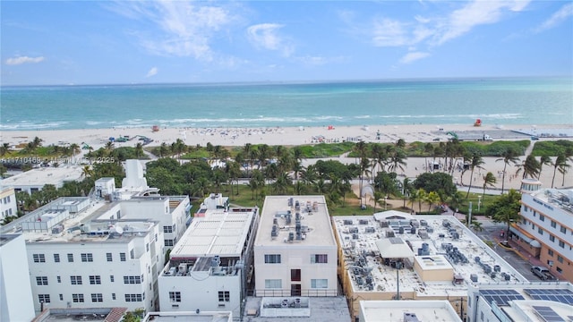 drone / aerial view with a water view and a beach view