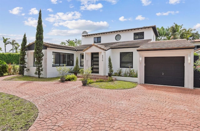 mediterranean / spanish house with a garage