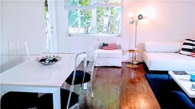 dining space with dark hardwood / wood-style floors and plenty of natural light