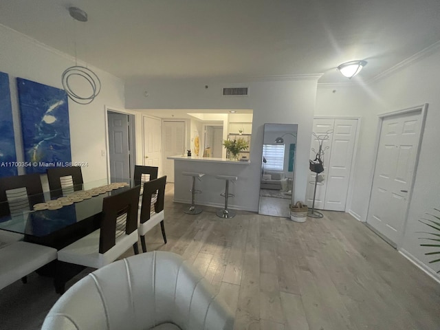 dining room featuring wood-type flooring and ornamental molding