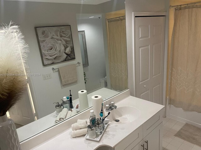 bathroom with tile patterned floors, shower / bath combo, and vanity