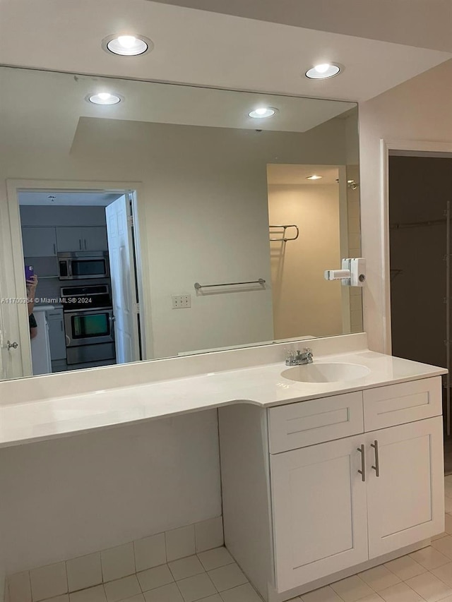 bathroom with tile patterned flooring and vanity