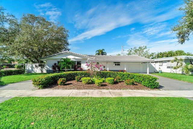 single story home with a front yard and a garage