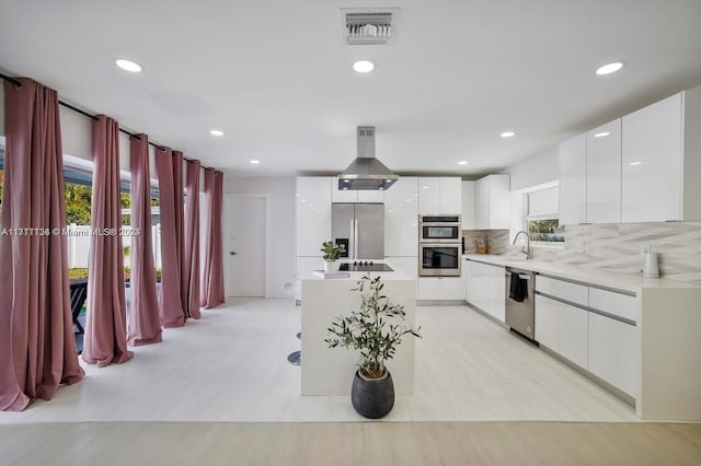 kitchen featuring tasteful backsplash, stainless steel appliances, extractor fan, light tile patterned floors, and white cabinetry