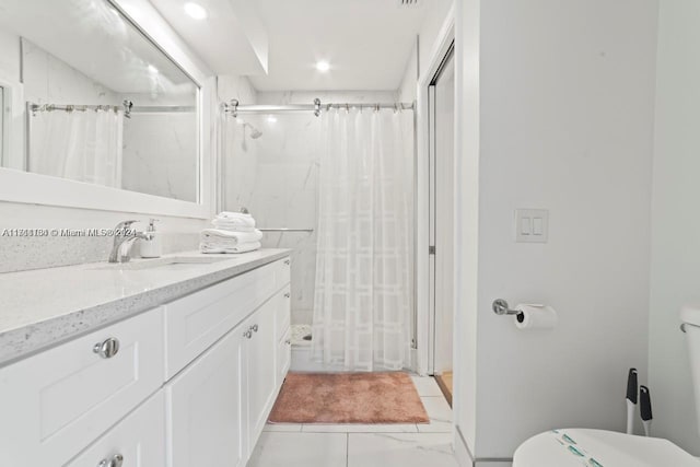 bathroom featuring vanity, curtained shower, and toilet