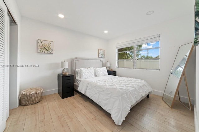 bedroom featuring light hardwood / wood-style flooring and a closet