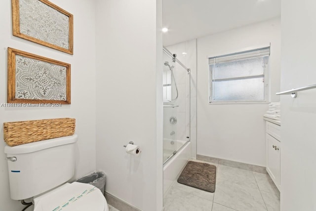 full bathroom featuring vanity, toilet, and bath / shower combo with glass door