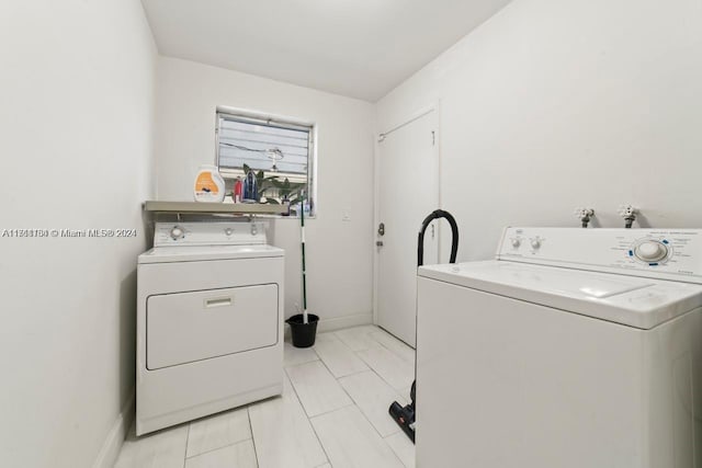 washroom featuring separate washer and dryer and light tile patterned flooring