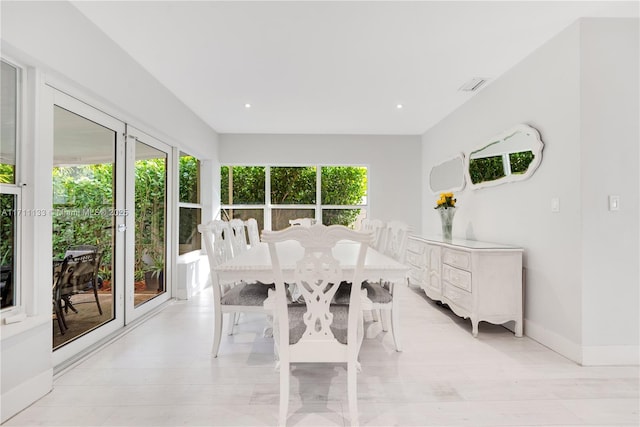 dining area with light wood-style floors, recessed lighting, visible vents, and baseboards