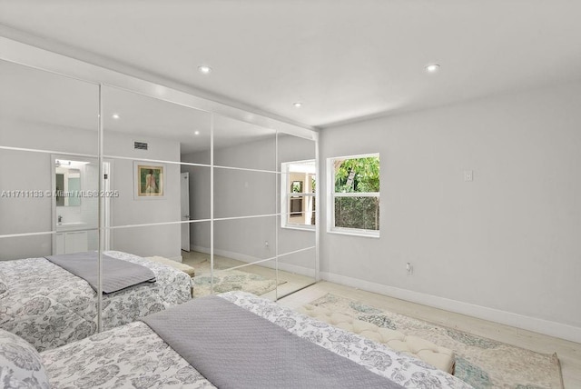 bedroom featuring baseboards, visible vents, and recessed lighting