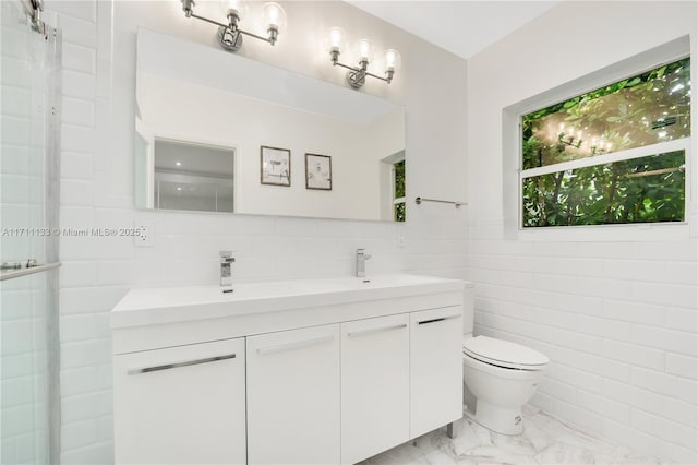 full bathroom with a shower with shower door, toilet, a sink, marble finish floor, and double vanity