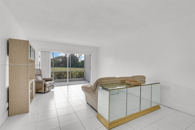 bedroom with light tile patterned flooring and access to exterior