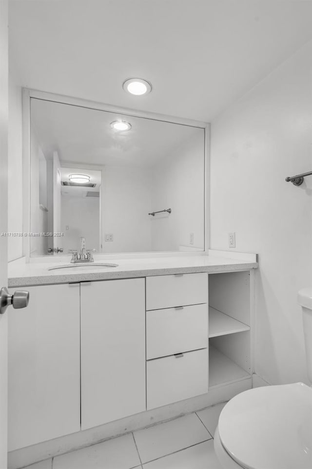 bathroom featuring tile patterned floors, vanity, and toilet