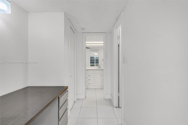 hall featuring light tile patterned floors