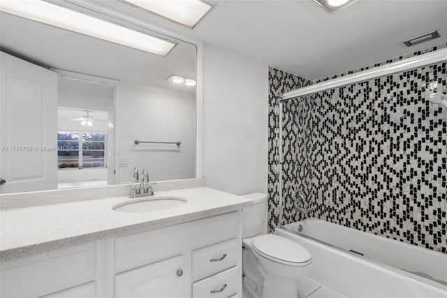 full bathroom with vanity, bath / shower combo with glass door, tile patterned flooring, ceiling fan, and toilet