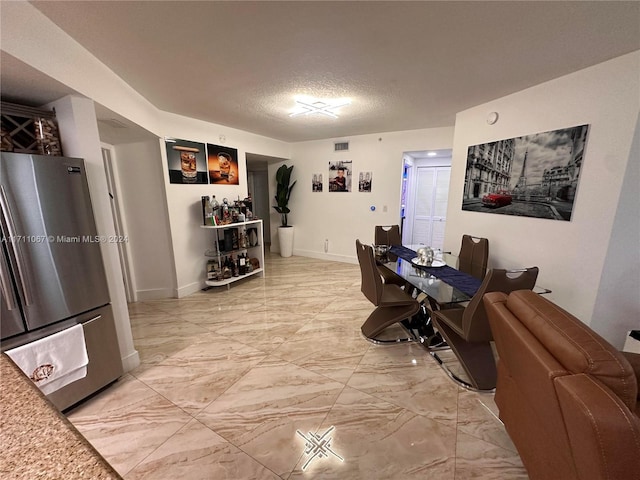 dining room with a textured ceiling