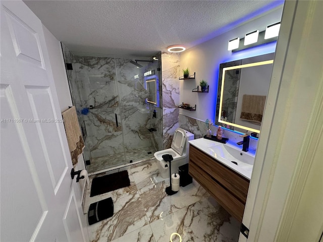 bathroom with vanity, a textured ceiling, toilet, and walk in shower