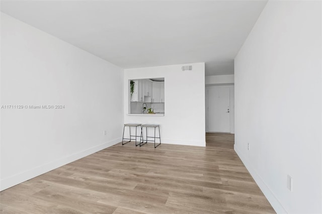 spare room featuring light hardwood / wood-style flooring