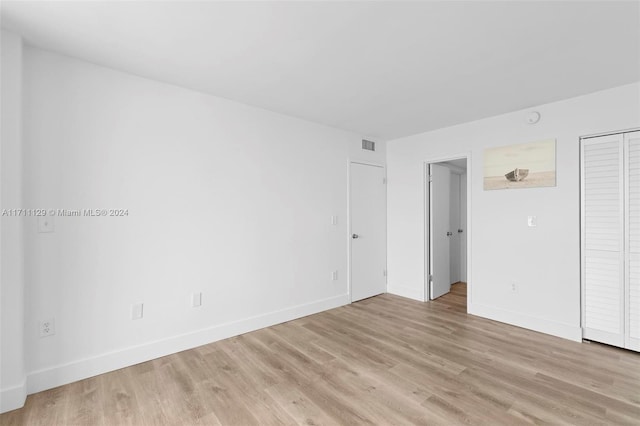 spare room with light wood-type flooring