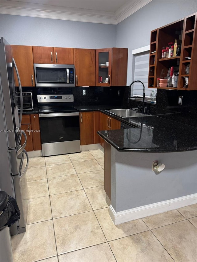 kitchen with dark stone counters, sink, light tile patterned floors, ornamental molding, and stainless steel appliances