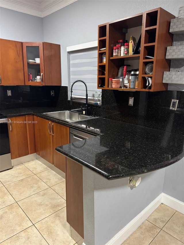 kitchen with sink, kitchen peninsula, crown molding, dark stone counters, and light tile patterned floors