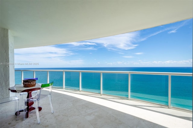 balcony with a water view and a beach view