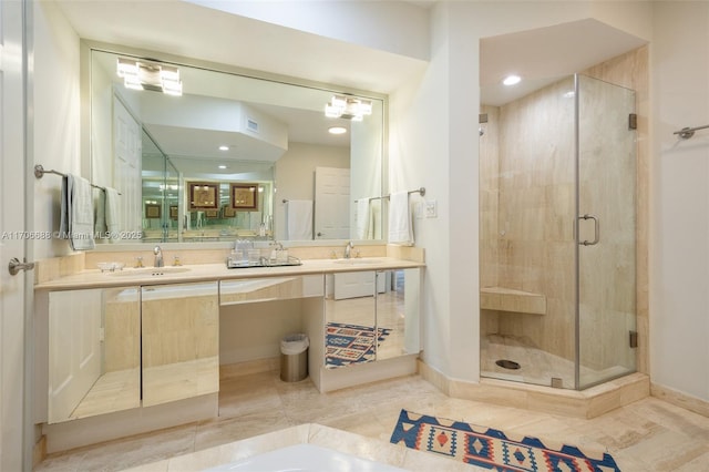 bathroom featuring tile patterned floors, vanity, and a shower with door