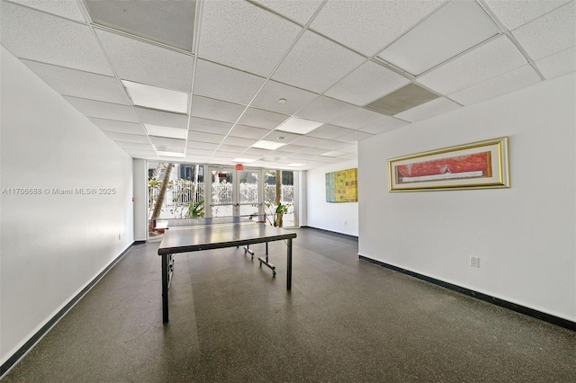 rec room with a drop ceiling and french doors